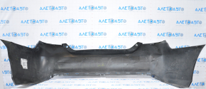 The rear bumper of a Toyota Camry V55 15-17 USA is black and dented, torn, and has broken fasteners.