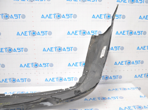The rear bumper of a Toyota Camry V55 15-17 USA is black and dented, torn, and has broken fasteners.