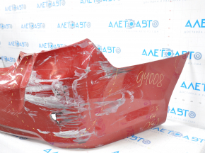 The rear bumper is bare, Toyota Camry v50 12-14 USA LE XLE red, dented, with tears and broken fasteners.