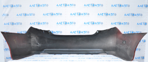 The rear bumper is bare, Toyota Camry v50 12-14 USA LE XLE red, dented, with tears and broken fasteners.