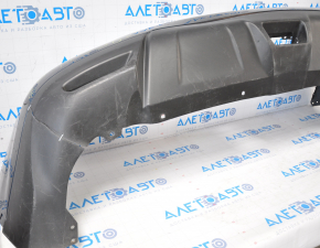 The rear bumper is bare, Nissan Rogue 14-16 blue, the left side is torn, the fasteners are torn, there is a dent in the center, and there are scratches.