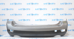 Subaru B10 Tribeca rear bumper, gray, with torn fasteners, dents, and scratches.