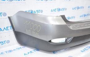 Subaru B10 Tribeca rear bumper, gray, with torn fasteners, dents, and scratches.