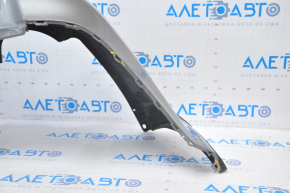 Subaru B10 Tribeca rear bumper, gray, with torn fasteners, dents, and scratches.