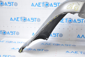 Subaru B10 Tribeca rear bumper, gray, with torn fasteners, dents, and scratches.