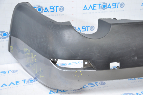 Subaru B10 Tribeca rear bumper, gray, with torn fasteners, dents, and scratches.