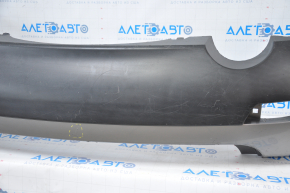 Subaru B10 Tribeca rear bumper, gray, with torn fasteners, dents, and scratches.