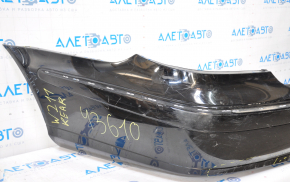 The rear bumper, bare, Mercedes W211 02-09, rest, black, is dented at the bottom, sawed off, the fastening is torn