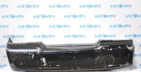 The rear bumper of a 98-11 Lincoln Town Car is bare and black, dented, with torn fasteners and missing right molding.