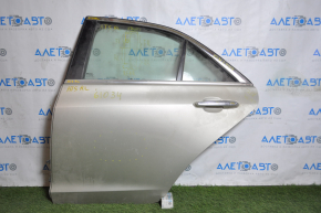 Rear left door assembly for a 1998 Cadillac ATS, silver, scratches