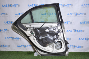 Rear left door assembly for a 1998 Cadillac ATS, silver, scratches