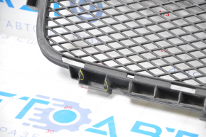The lower grille of the front bumper of the Lexus GS300 GS350 GS430 GS450h 06-07 has tears in the fasteners and is dented.