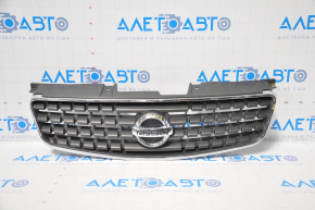 Nissan Alltima 2005 USA radiator grille has chrome breakage, tears, broken fasteners, torn guides, and a bump on the emblem.