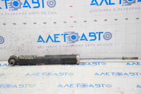 The rear left shock absorber of a Toyota Prius V 12-14 is dented.