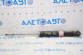 The rear left shock absorber of a Toyota Prius V 12-14 is dented.