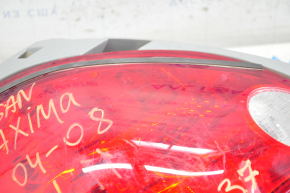 Left headlight Nissan Maxima 04-08 scratches on glass, broken corner