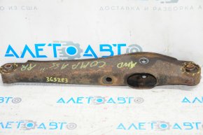 The lower rear right control arm of a Jeep Compass 11-16 is rusty and the silent blocks are torn.