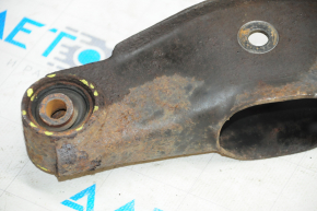 The lower rear right control arm of a Jeep Compass 11-16 is rusty and the silent blocks are torn.