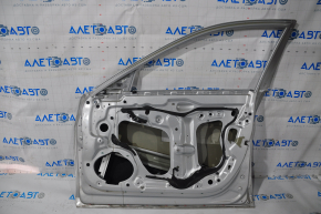 The front right door of a Cadillac CTS 14-19 is bare, with a dent near the hinges, silver.