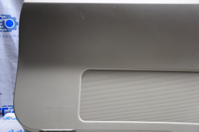 Lower tailgate trim Jeep Patriot 11-17 beige, plastic turned white, scratches