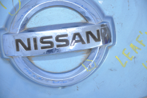 Front cover of charging port nose Nissan Leaf 13-14 under camera, with badge, dented, scratches, crack, badge rubbed off