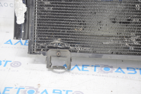 The air conditioning condenser radiator of a Toyota Corolla e12 02-06 is crushed, and the honeycombs are falling out.