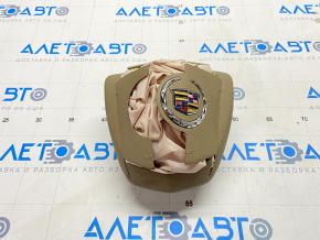 Airbag in the driver's steering wheel of a 1920s Cadillac CTS pre-restoration, beige, shot