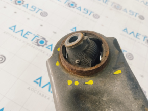 The lower front left control arm of a 14-20 Nissan Rogue has a torn silent block.