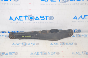 The lower rear left control arm of a Dodge Journey 11-20 has a torn silent block and is rusty.