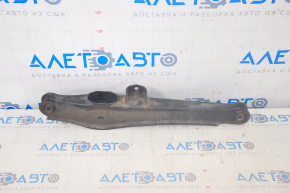 The lower rear left control arm of a Dodge Journey 11-20 has a torn silent block and is rusty.