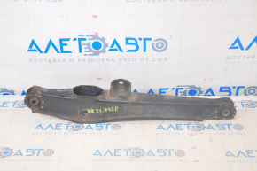 The lower rear right control arm of a Dodge Journey 11-20 has a torn silent block and is rusty.