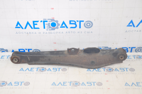 The lower rear right control arm of a Dodge Journey 11-20 has a torn silent block and is rusty.