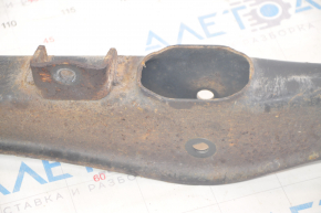 The lower rear right control arm of a Dodge Journey 11-20 has a torn silent block and is rusty.
