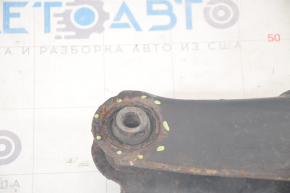 The lower rear right control arm of a Dodge Journey 11-20 has a torn silent block and is rusty.