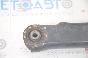 The lower rear right control arm of a Dodge Journey 11-20 has a torn silent block and is rusty.
