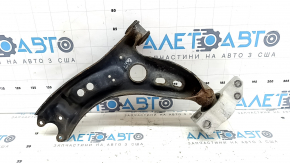 The lower front right control arm of a VW Tiguan 09-17 is rusty.