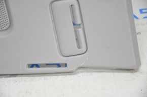 The rear shelf of a Toyota Camry v40 is gray, worn, and has scratches.