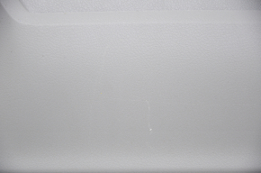 The rear shelf of a Toyota Camry v40 is gray, worn, and has scratches.