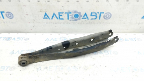 The lower rear left control arm of a Subaru Impreza WRX GH 08-14 is rusty.
