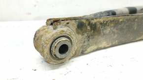 The lower rear left control arm of a Subaru Impreza WRX GH 08-14 is rusty.