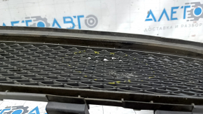 The lower grille of the front bumper of the Mercedes CLA 17-19 is dented, cracks