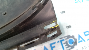 The lower grille of the front bumper of the Mercedes CLA 17-19 is dented, cracks