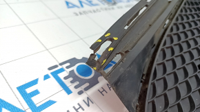 The lower grille of the front bumper of the Mercedes CLA 17-19 is dented, cracks
