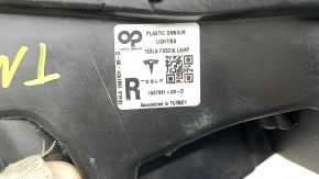 Tesla Model Y 20-25 right fog light with broken mount, scratches, and sand