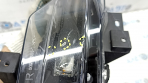 Tesla Model Y 20-25 right fog light with broken mount, scratches, and sand