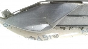 The front bumper lip of a Ford Escape MK4 20-22 for parking sensors is dented.