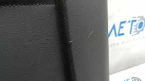 Tesla Model Y 20-25 rear passenger seat trim panel is black, with broken fasteners and scratches.