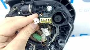 The airbag in the driver's steering wheel of a BMW 3 G20 19-24 is black and the mount is broken.