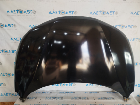 The hood of a 2017-2019 Nissan Rogue Sport is bare steel and dented.