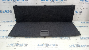 The trunk floor of a 12-14 Toyota Prius V is dark gray, scratches, and needs cleaning.